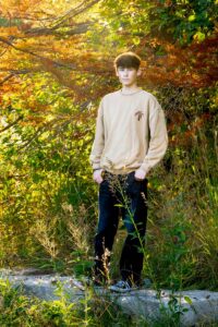 Avery's Senior Photography Session -standing with fall leaves